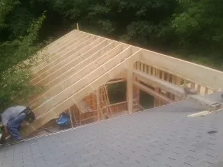 Framing a new roof addition that ties into an existing shingle roof in Revloc